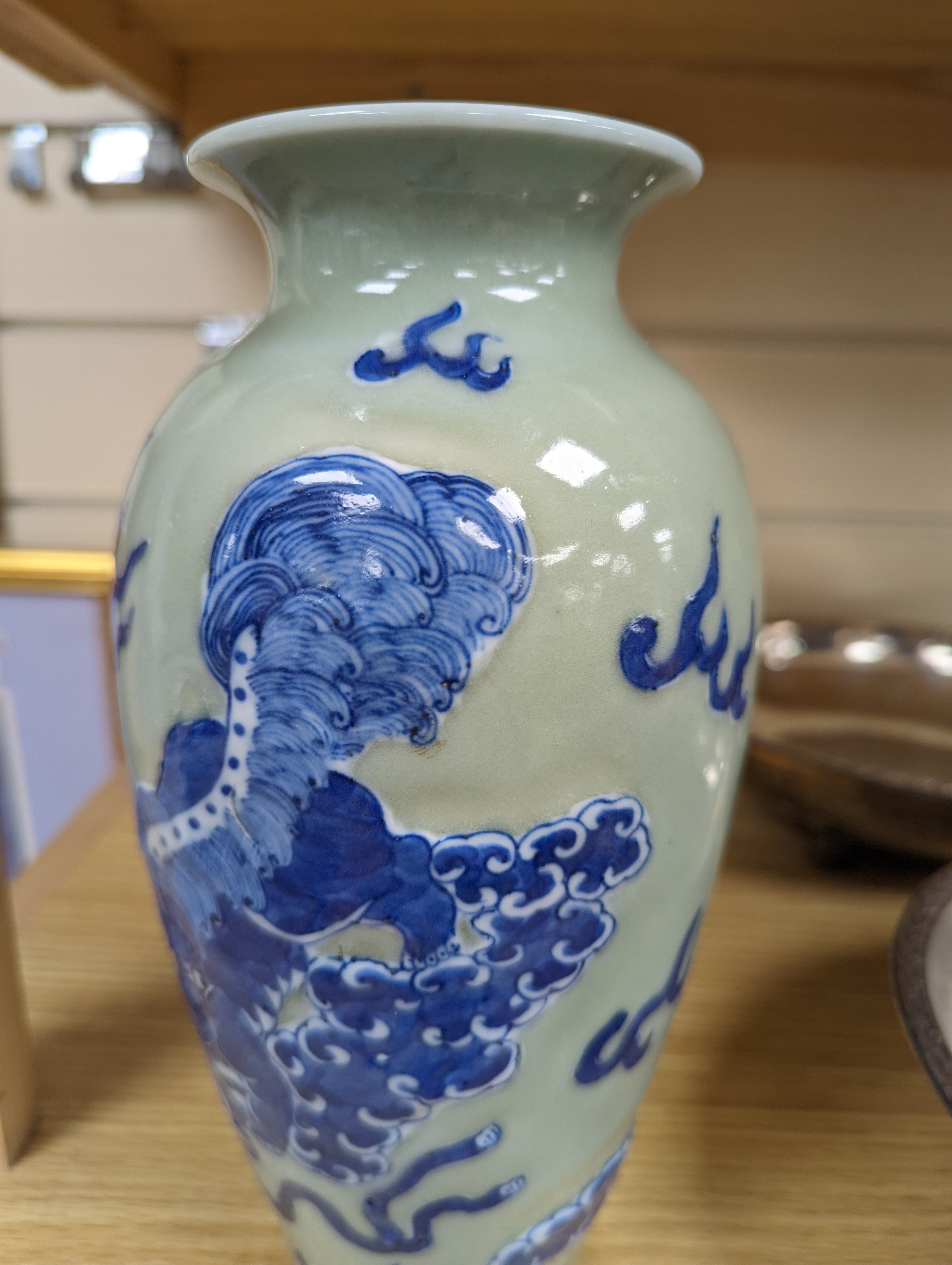 A Chinese celadon glazed vase, 24cm and a Chinese famille rose teapot and matching cream jug, a.f.